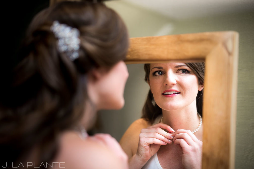 Edgewood Inn Wedding | Colorado Springs Wedding Photographer | Bride putting necklace on | J La Plante Photo