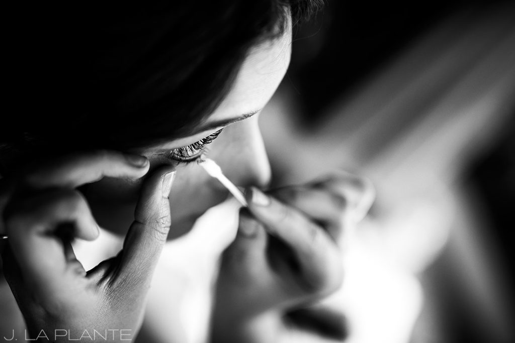 bride getting makeup done before wedding