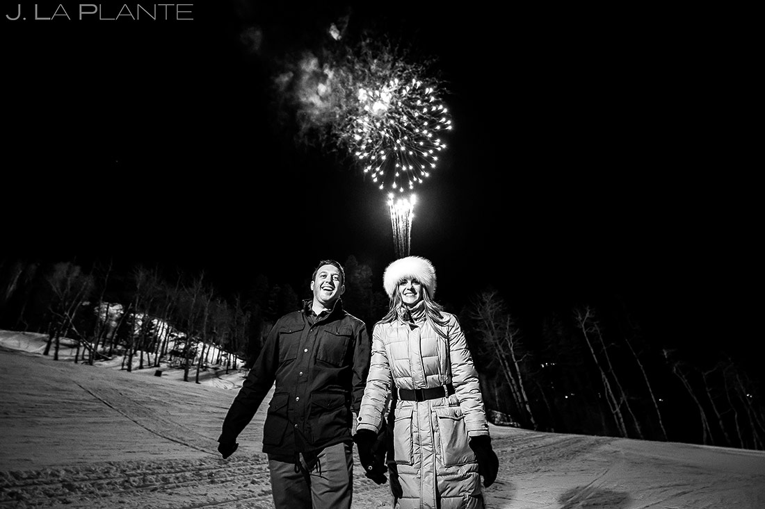 bride and groom watching fireworks during their beaver creek engagement 