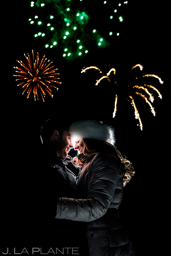 bride and groom watching fireworks during their beaver creek engagement 