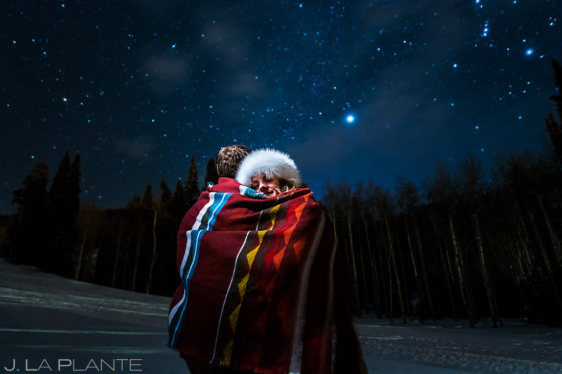 bride and groom under the stars during their beaver creek engagement 