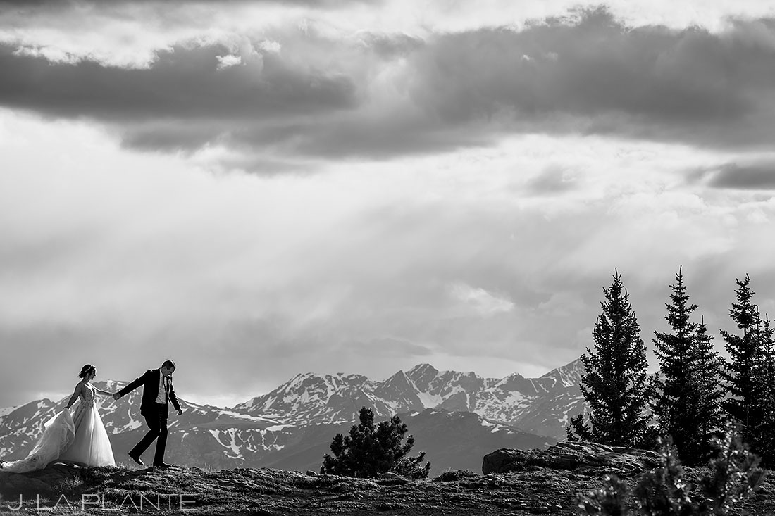bride and groom hiking in the rocky mountains