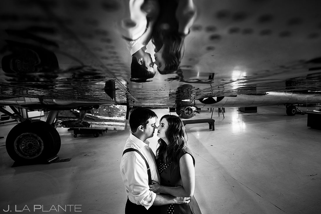 bride and groom under the wing of a plane