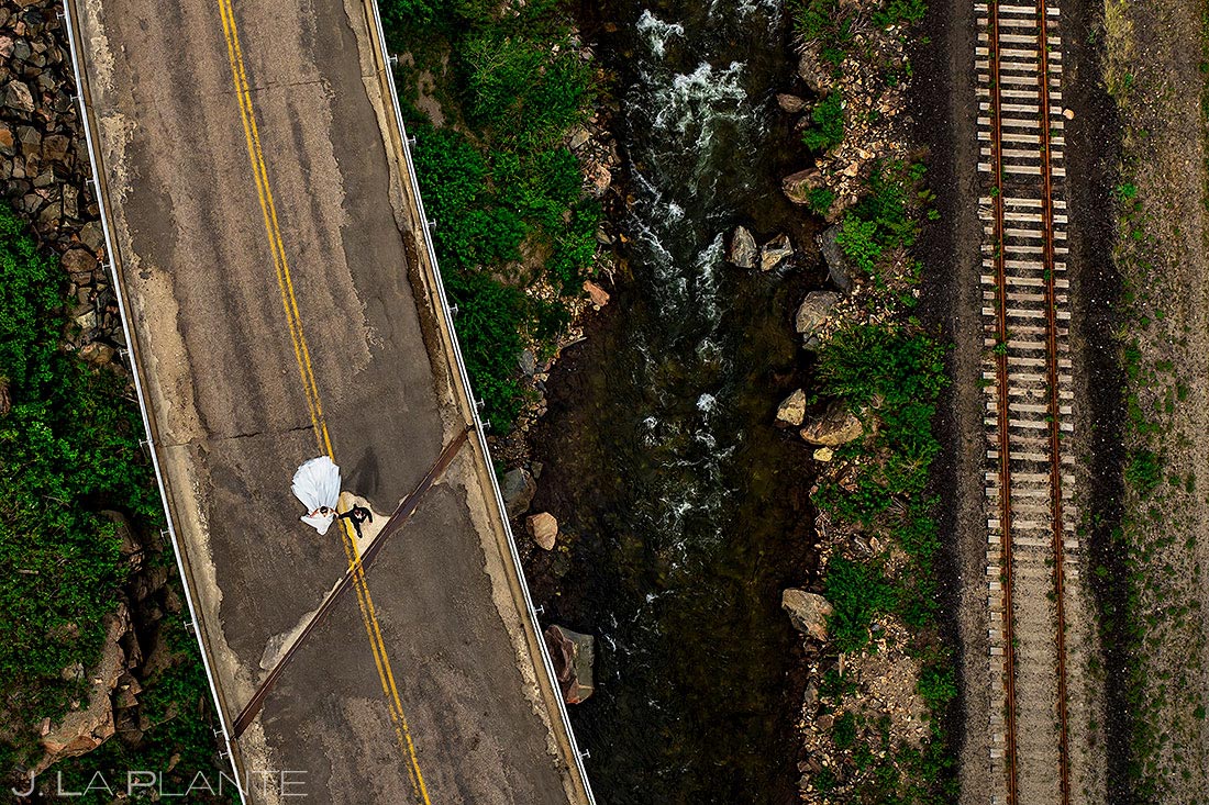 drone shot of bride and groom walking down street