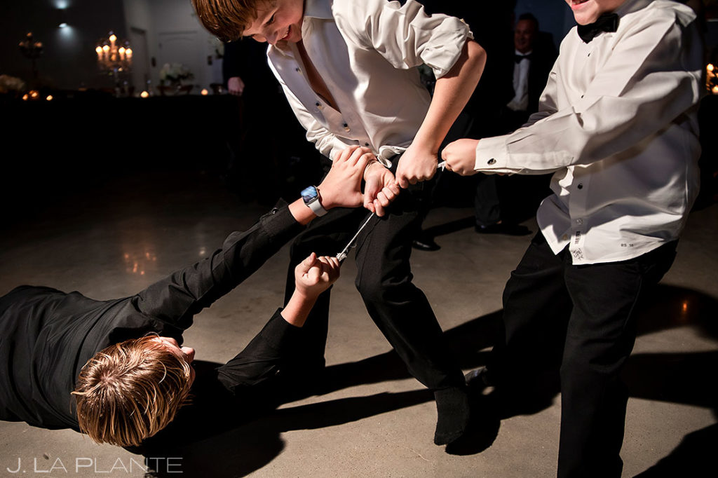 kids fighting over bride's garter during houston wedding