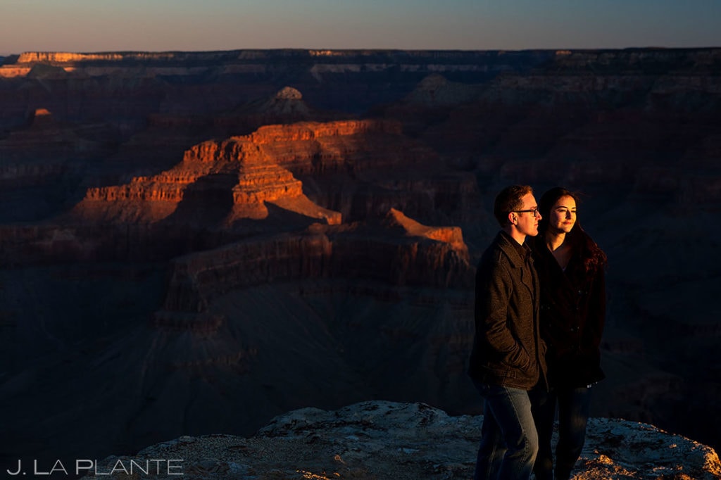 bride and groom to be watching the sunrise at the Grand Canyon