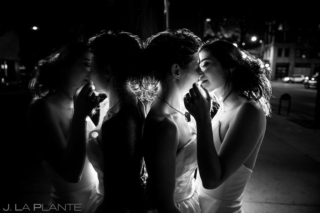 two brides kissing in city street after their wedding at the Grand Hyatt Downtown Denver