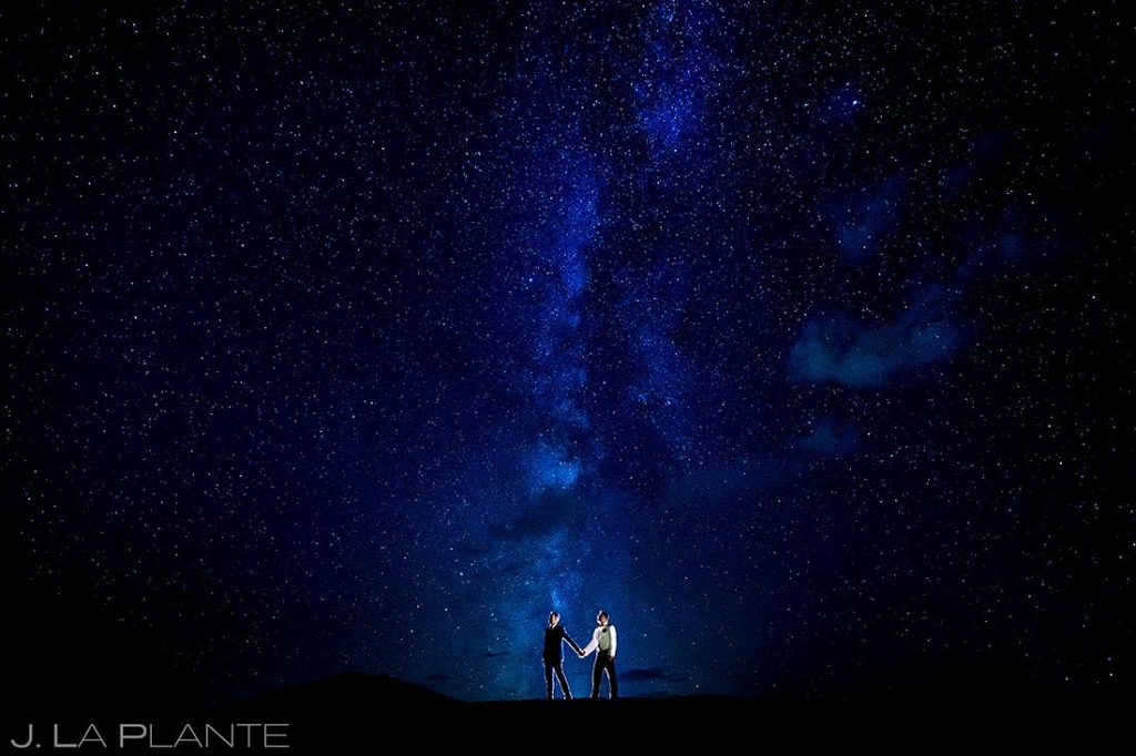 nighttime wedding photos of two grooms under the stars in Aspen Colorado