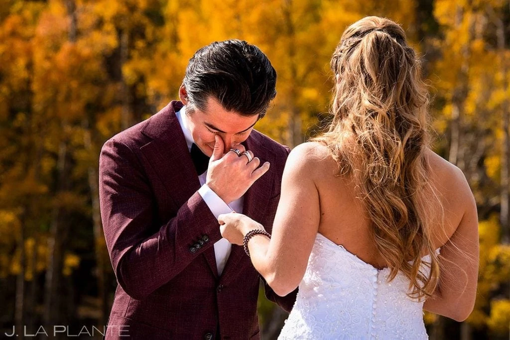 groom cyring during first look in Rocky Mountain National Park