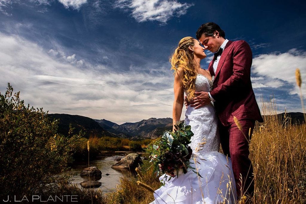 bride and groom by river in Colorado