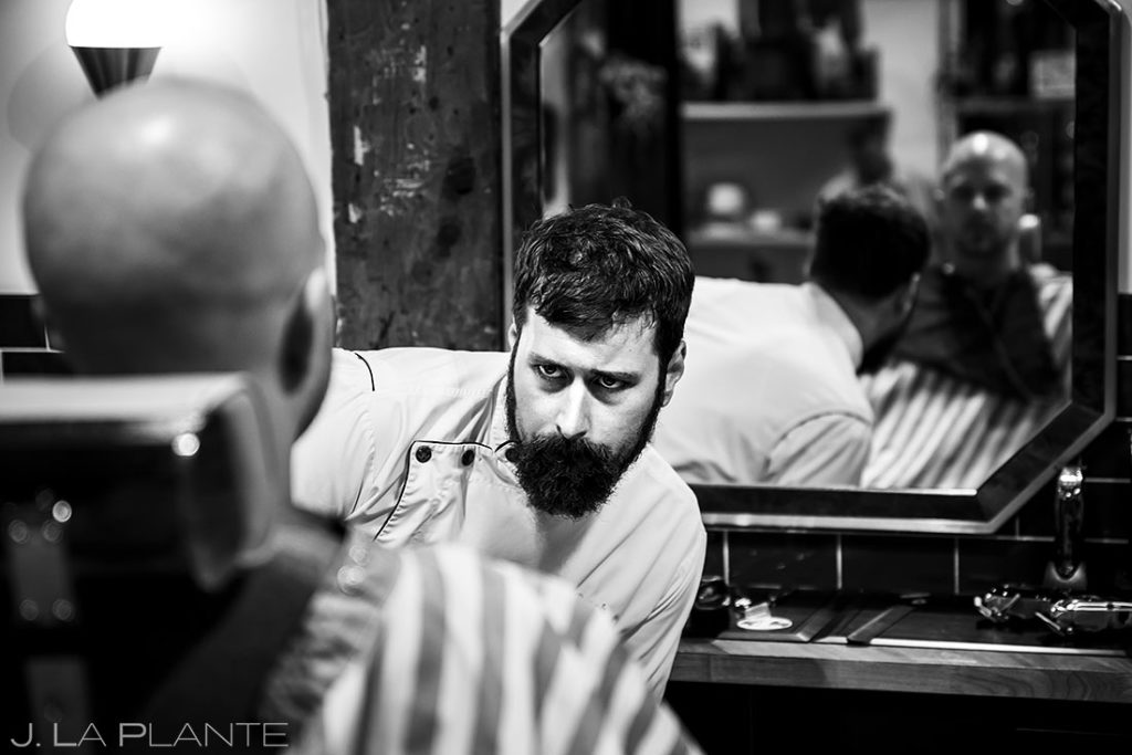groom getting a shave at barbershop before Wellshire Event Center wedding