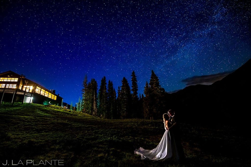bride and groom kissing under the stars during Arapahoe Basin wedding