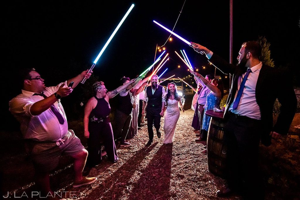 bride and groom light saber send off at backyard wedding in Boulder