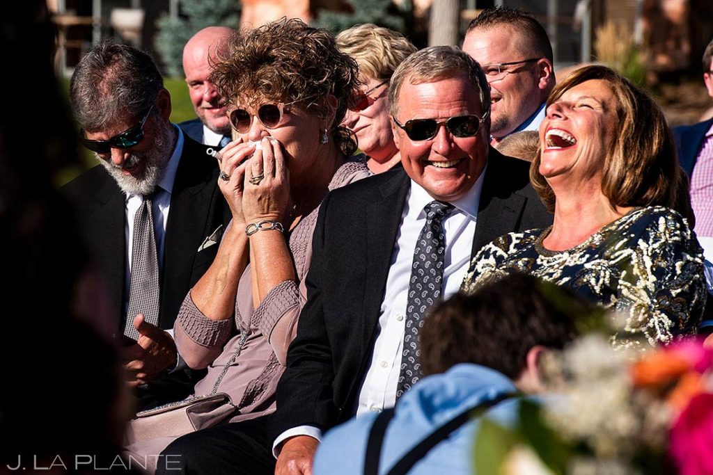 parents of the groom laughing during ceremony