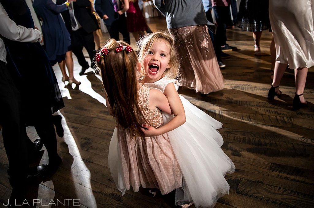 flower girl dancing with friend during wedding reception