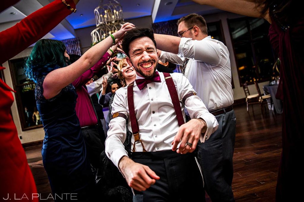 groom doing the limbo on the dance floor