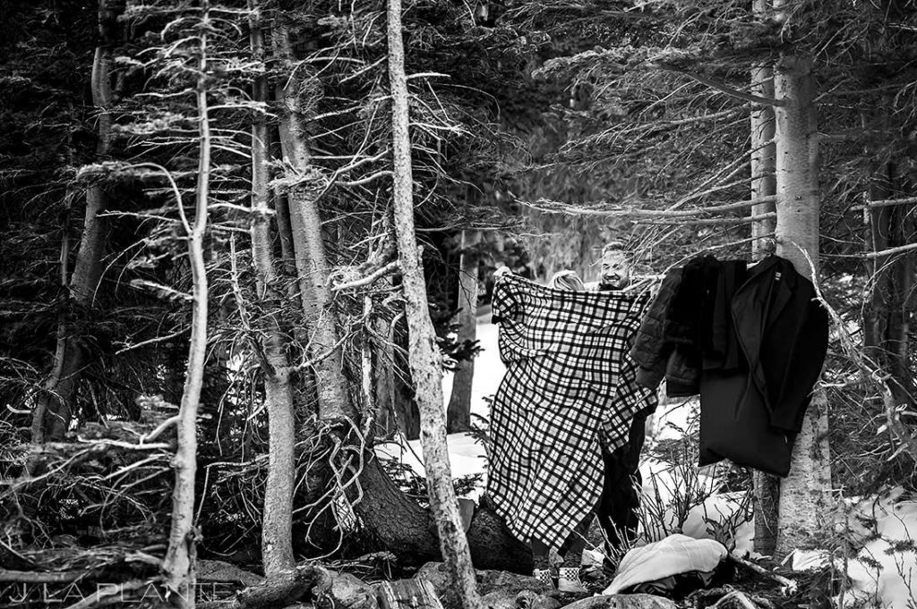 bride to be changing clothes in the snowy mountains