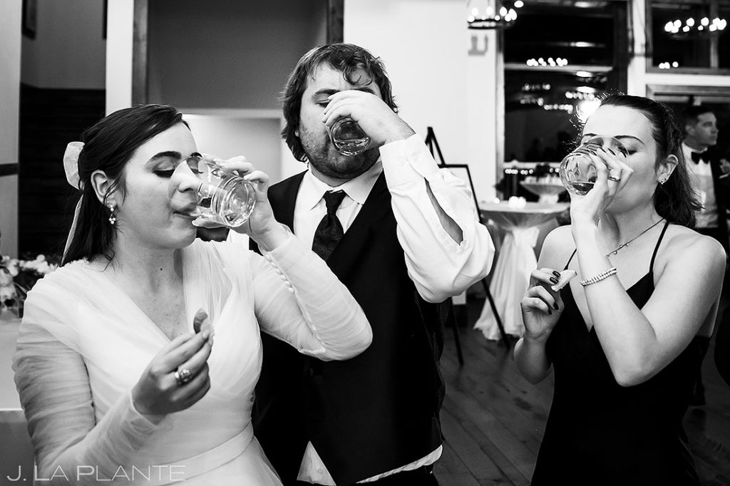 bride doing tequila shots with wedding guests