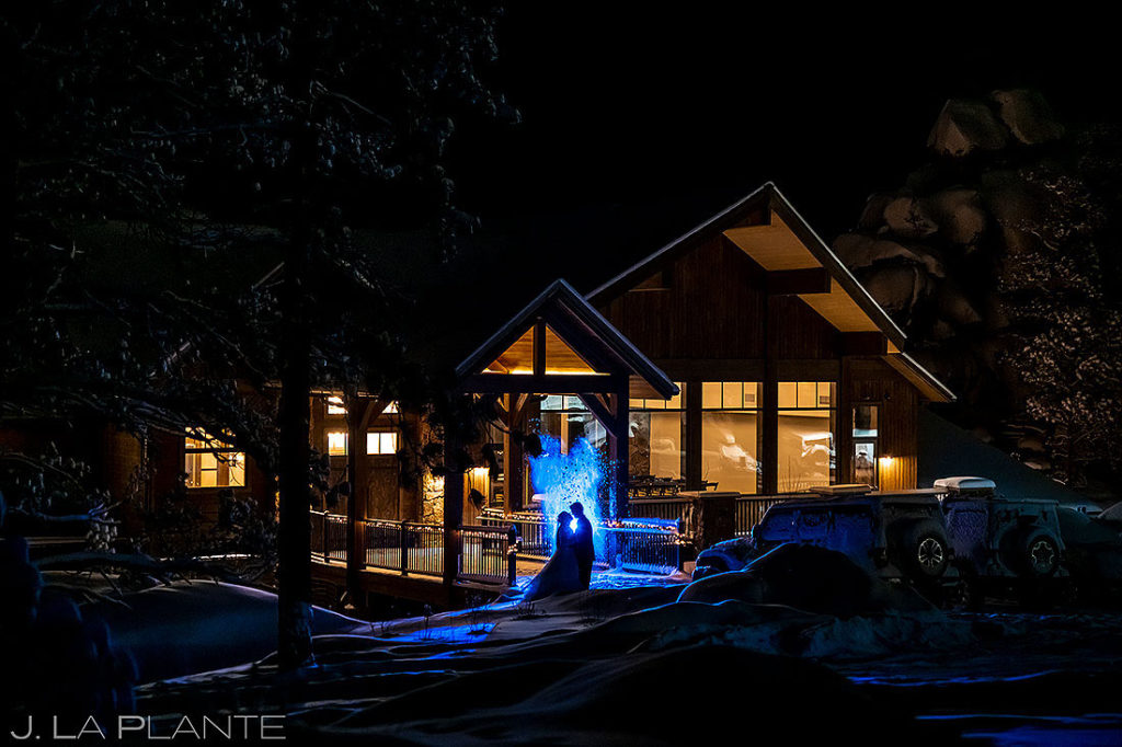 nighttime wedding portrait of bride and groom in snow