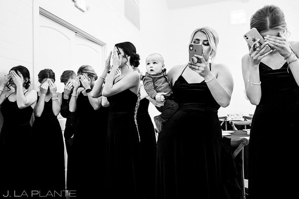 funny toddler looking at bride during first look