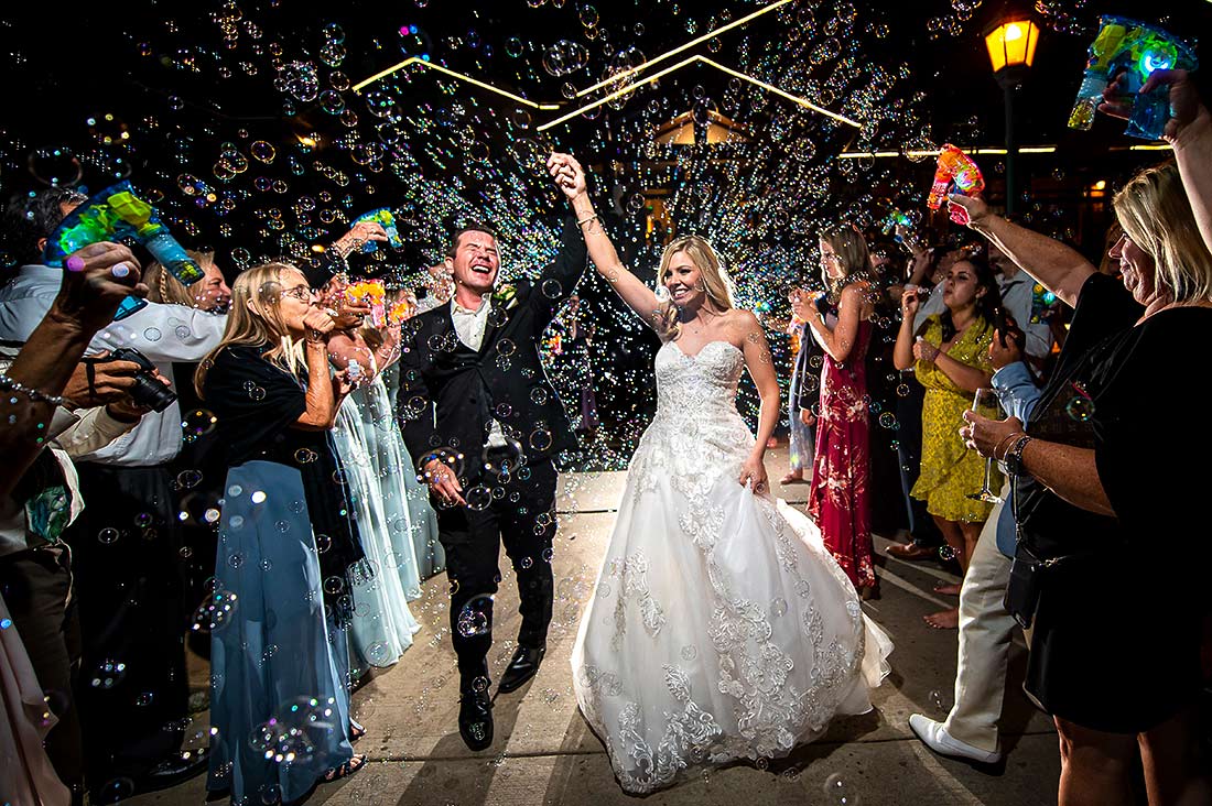 vibrant wedding photography bride and groom bubble send off