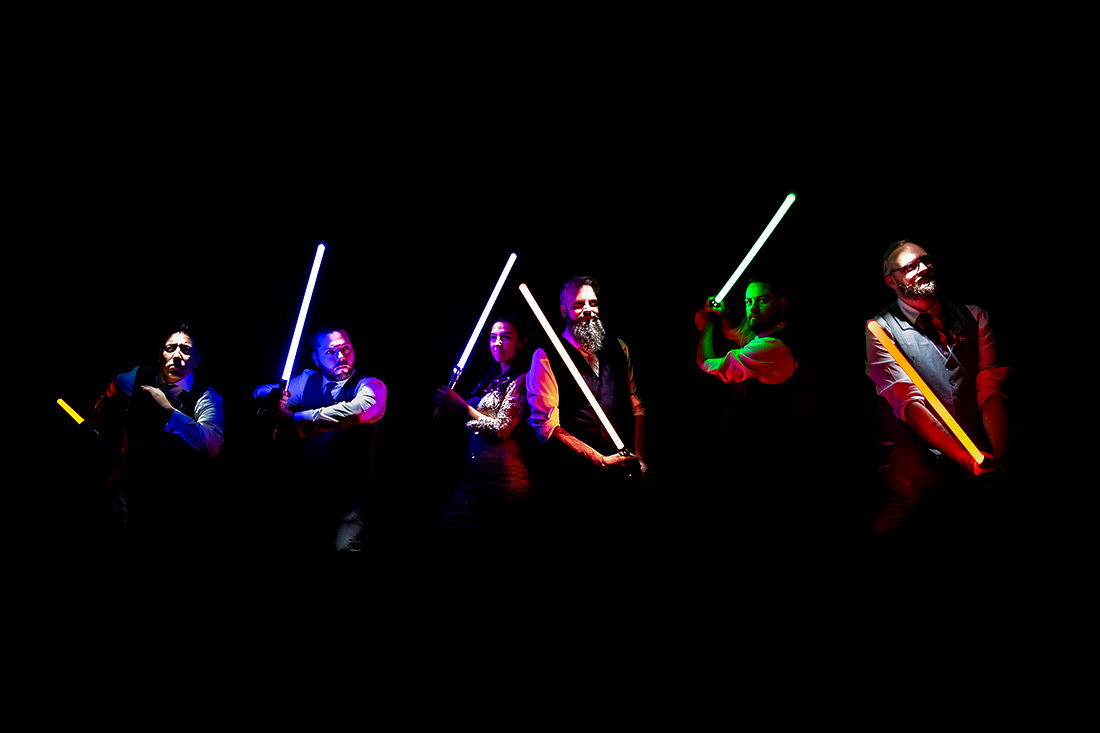 wedding party with lightsabers during Star Wars themed wedding