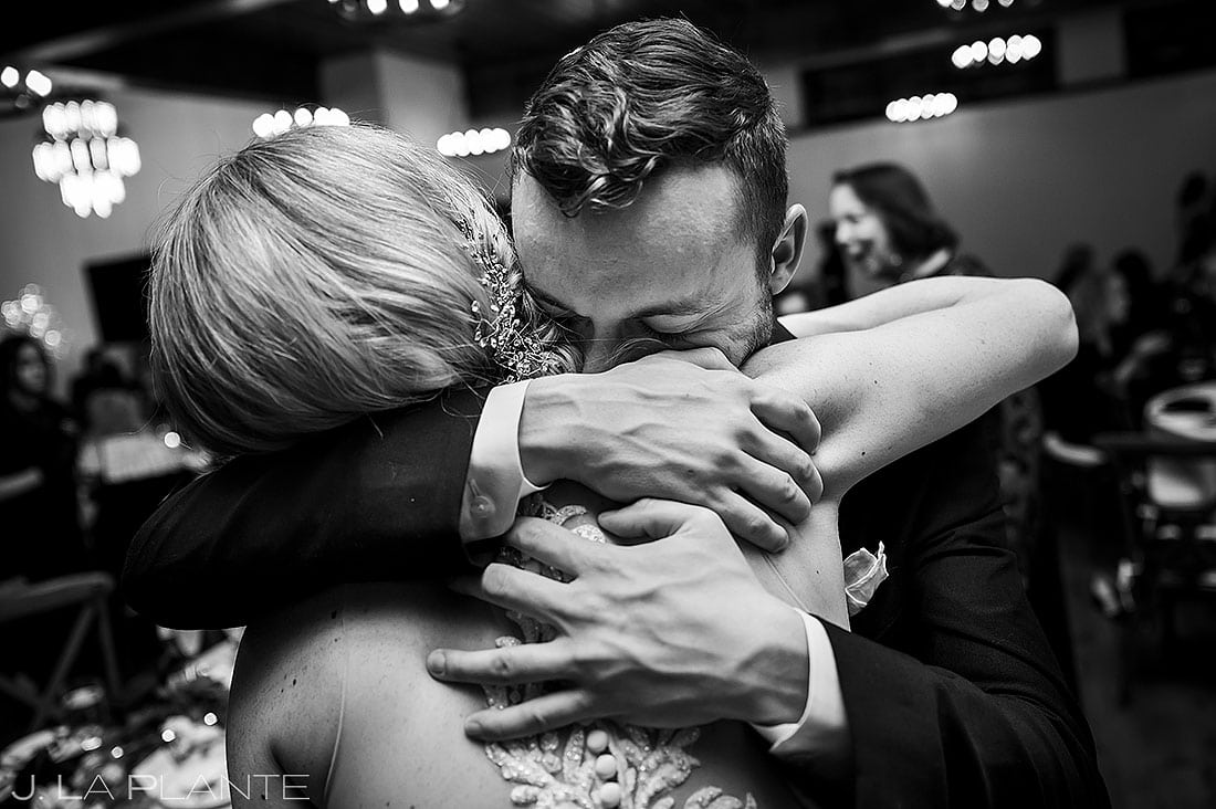 bride hugging brother of groom during reception