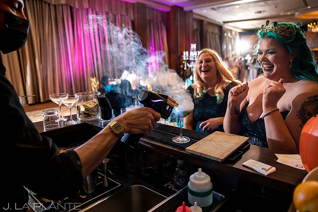 bride watching bartender make cool signature cocktails