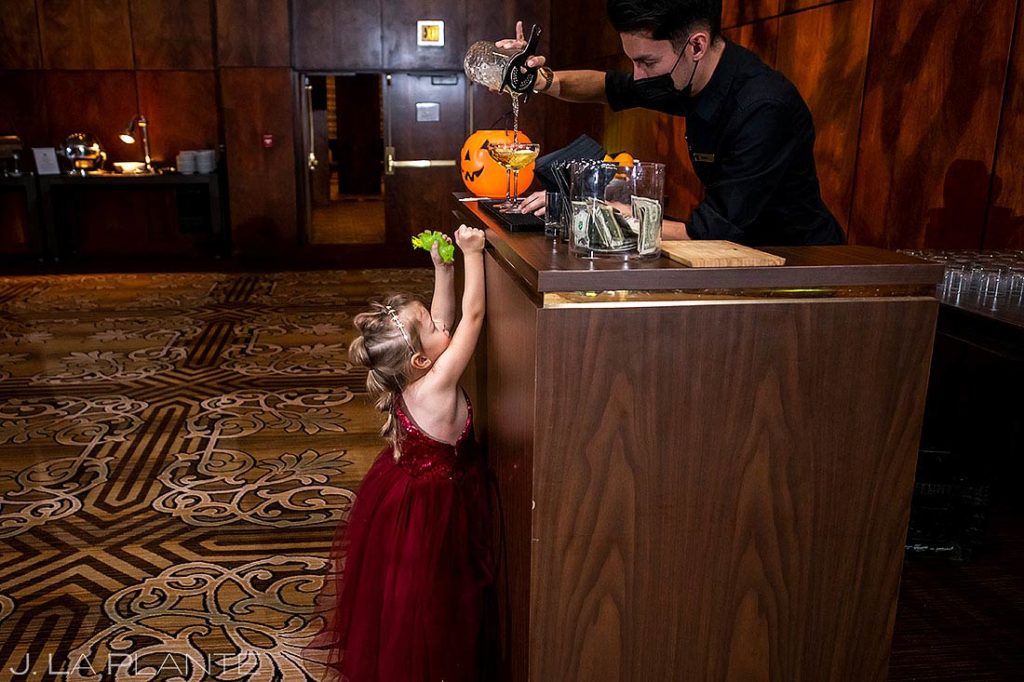 bartender pouring non alcoholic drink for child during wedding reception