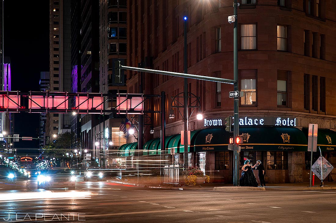 bride and groom on city street at nighttime in downtown Denver
