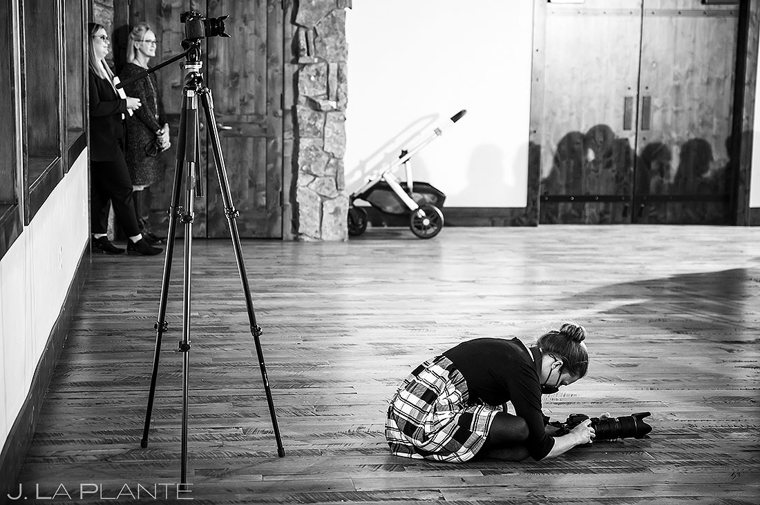 wedding photography behind the scenes photographer getting low angle on ceremony