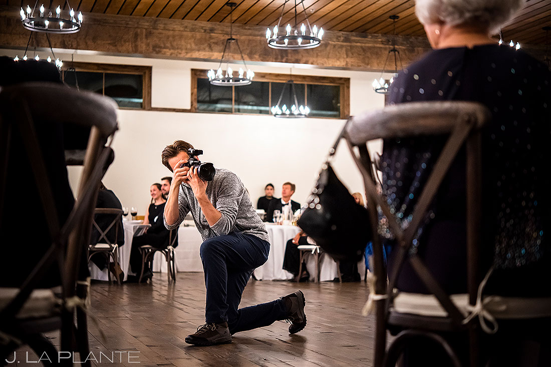 wedding photography behind the scenes photographer shooting toasts during reception