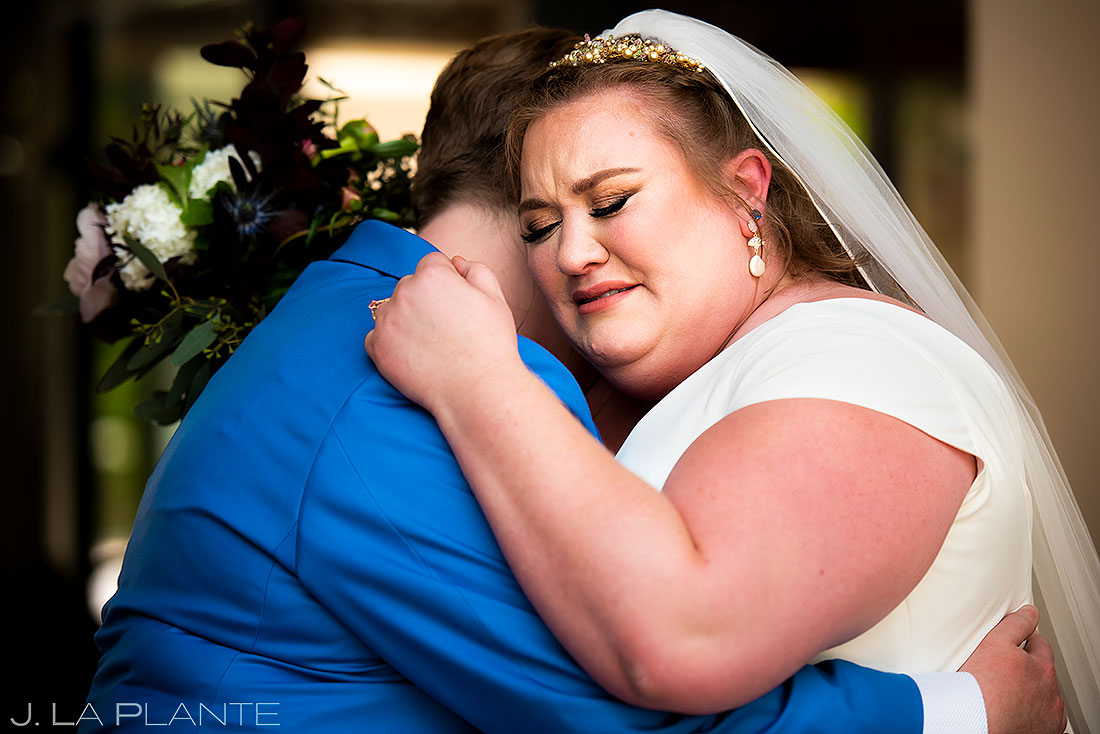 bride and bride hugging during first look
