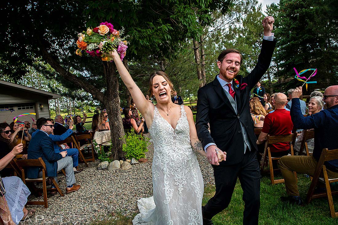 bride and groom leaving ceremony at backyard wedding in longmont