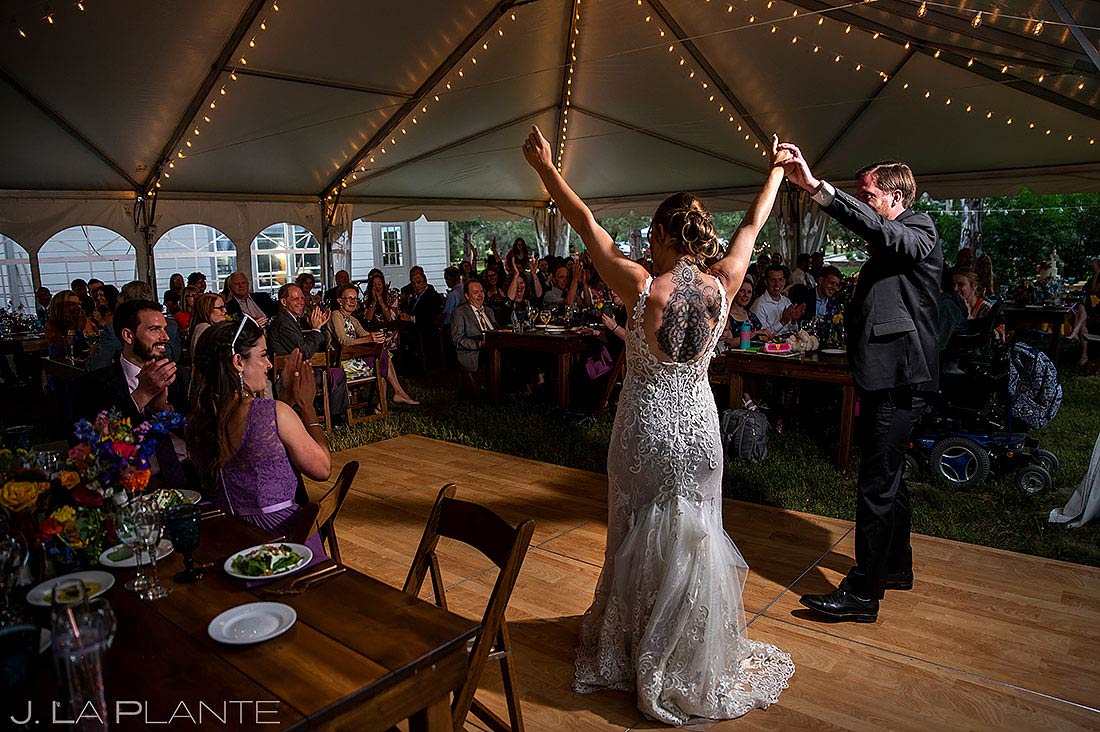 bride and groom first dance under reception tent