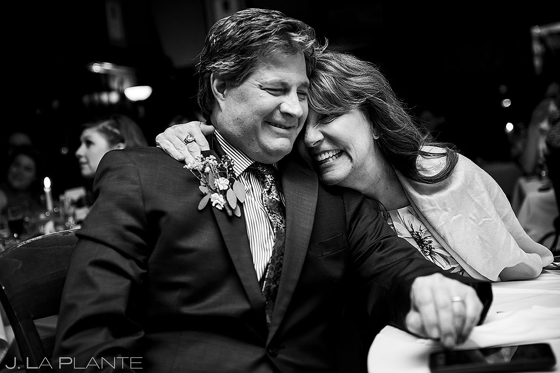 parents of the bride hugging during toasts