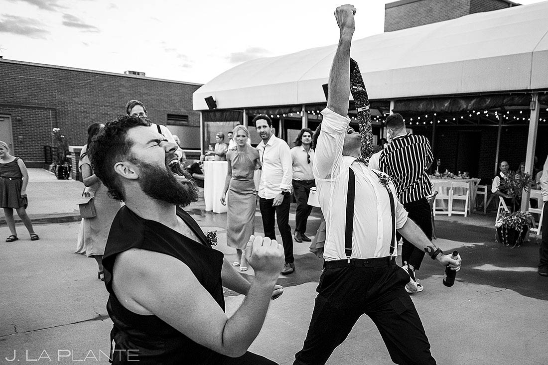 groom dancing with groomsman during reception