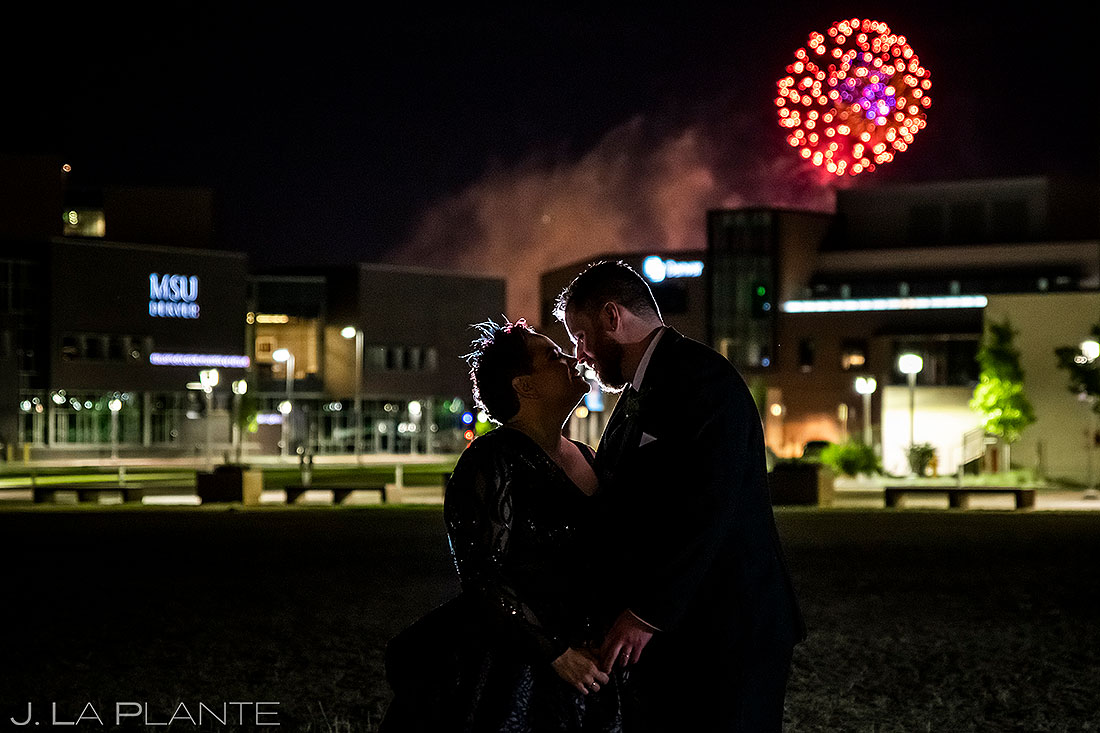 bride and groom kissing under fireworks