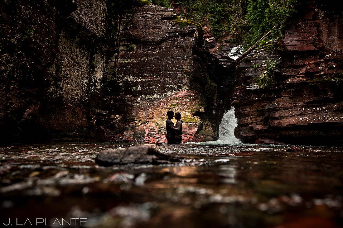 bride and groom portrait next to waterfall