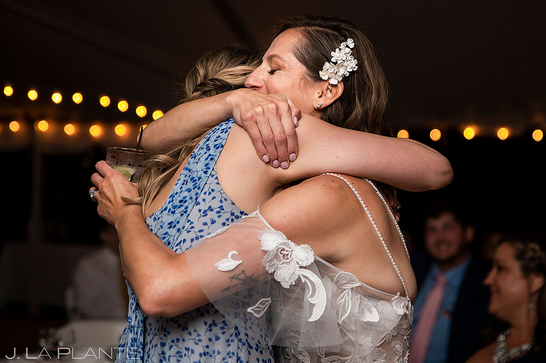 bride hugging sister during wedding reception
