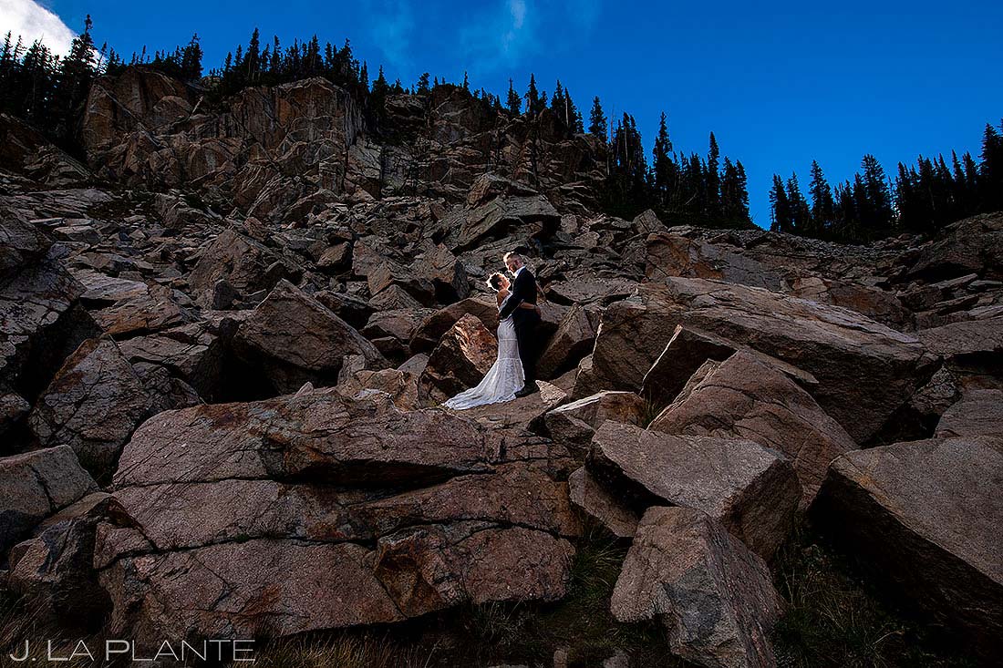 bride and rocks climbing rocks in Colorado