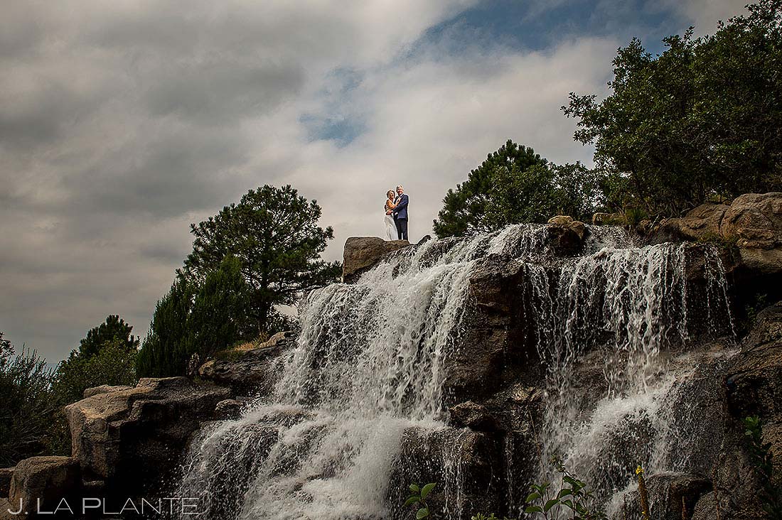 bride and groom on waterfall at sanctuary wedding