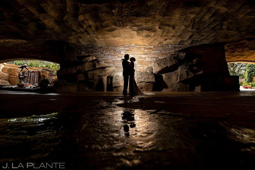 bride and groom in grotto at sanctuary wedding