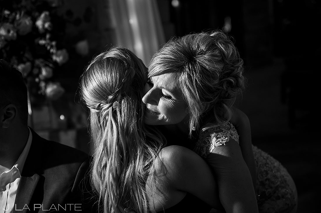 bride hugging daughter during wedding toasts