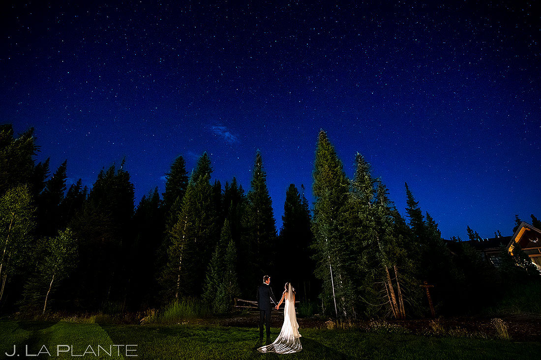 bride and groom holding hands under the stars