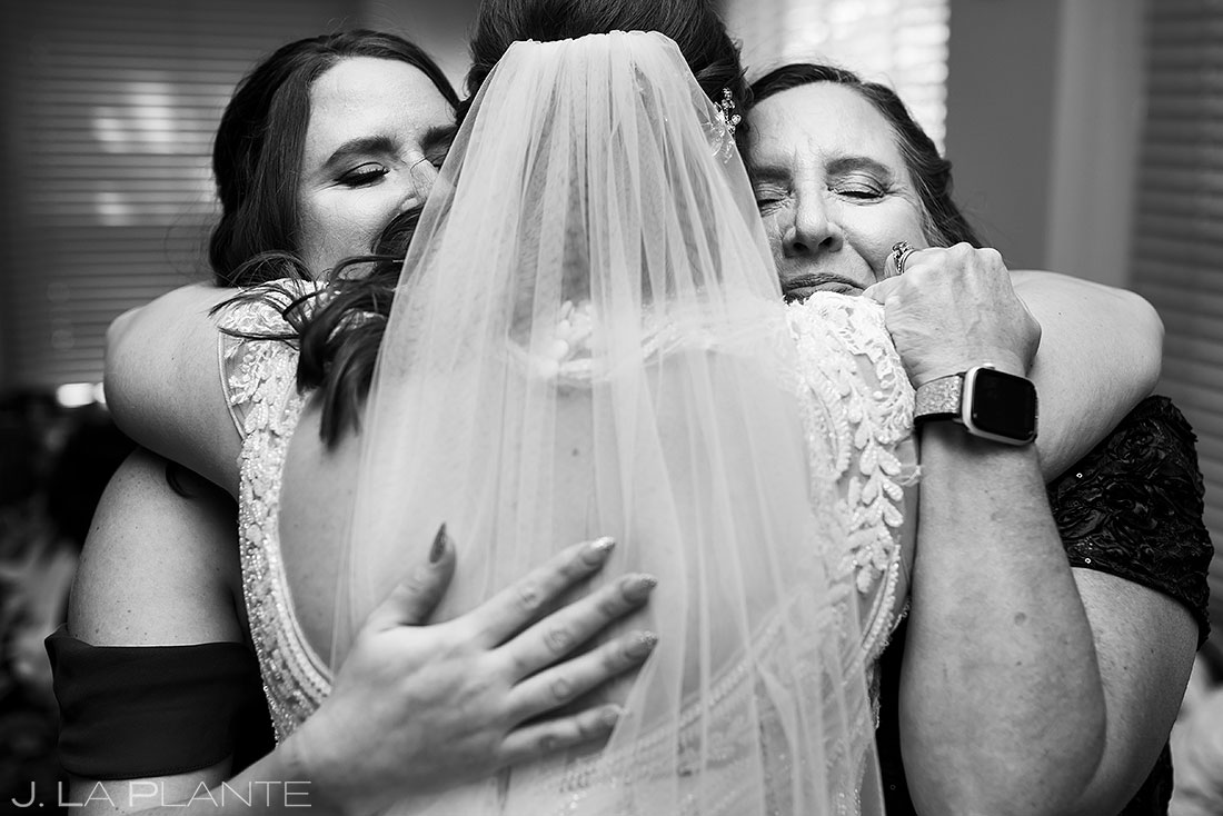 bride hugging mother before fall wedding at Boettcher Mansion wedding