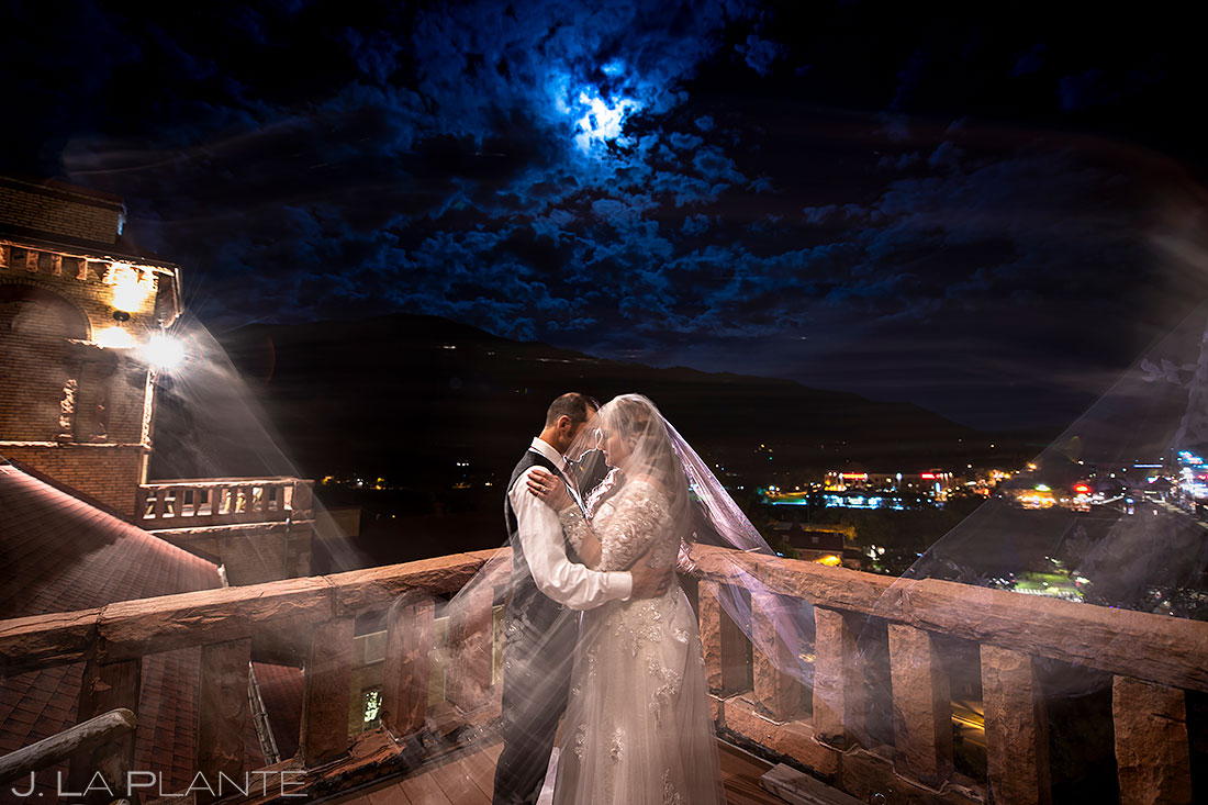 bride and groom kissing under full moon