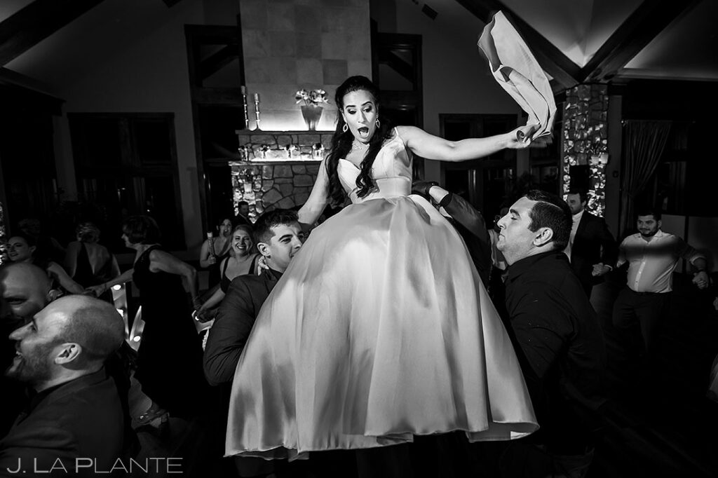bride being lifted into the air at Cielo at Castle Pines wedding