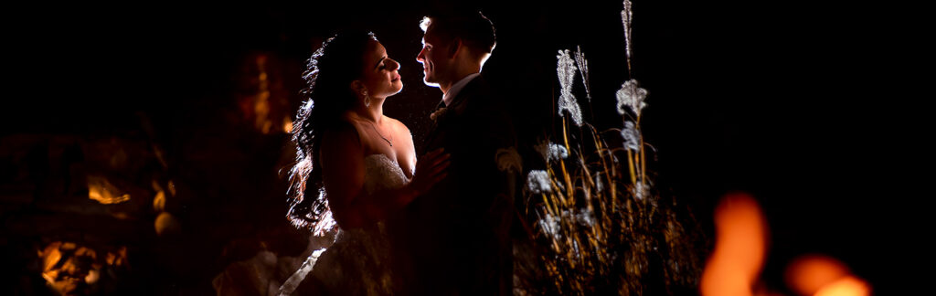 bride and groom by the fire at Cielo at Castle Pines wedding
