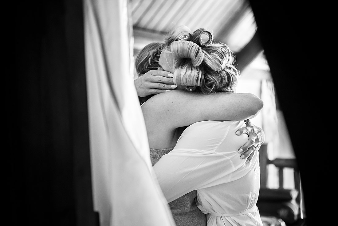 bride crying while hugging her mother